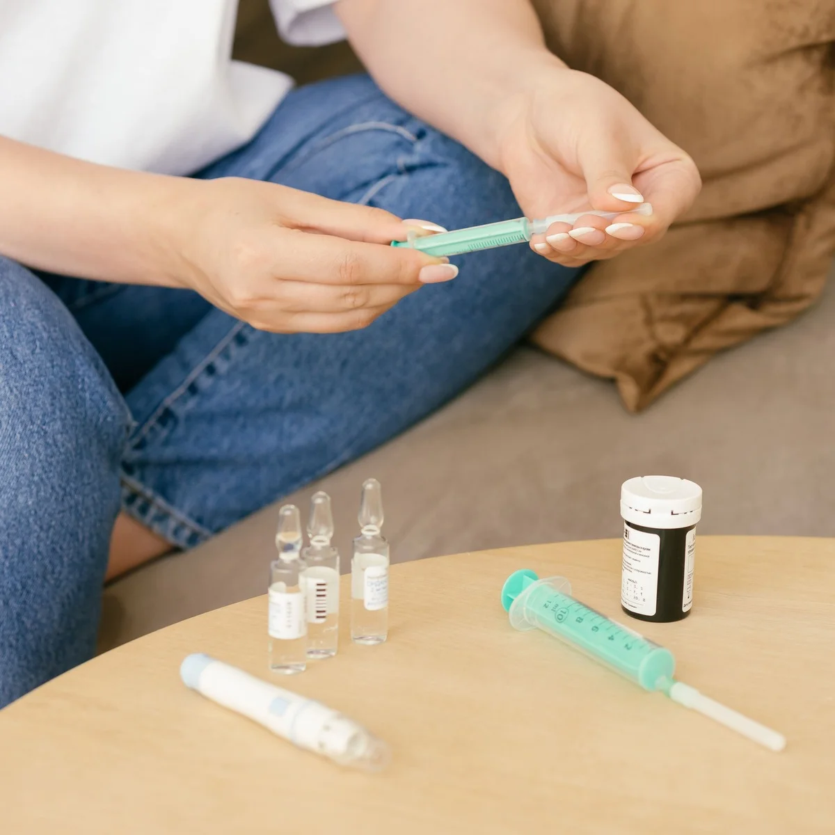 Hormone vials and a dosing pen on a side table